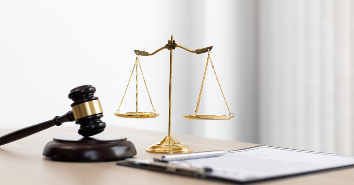 A gavel and justice scale symbolizing compassion and the importance of ethics in healthcare.