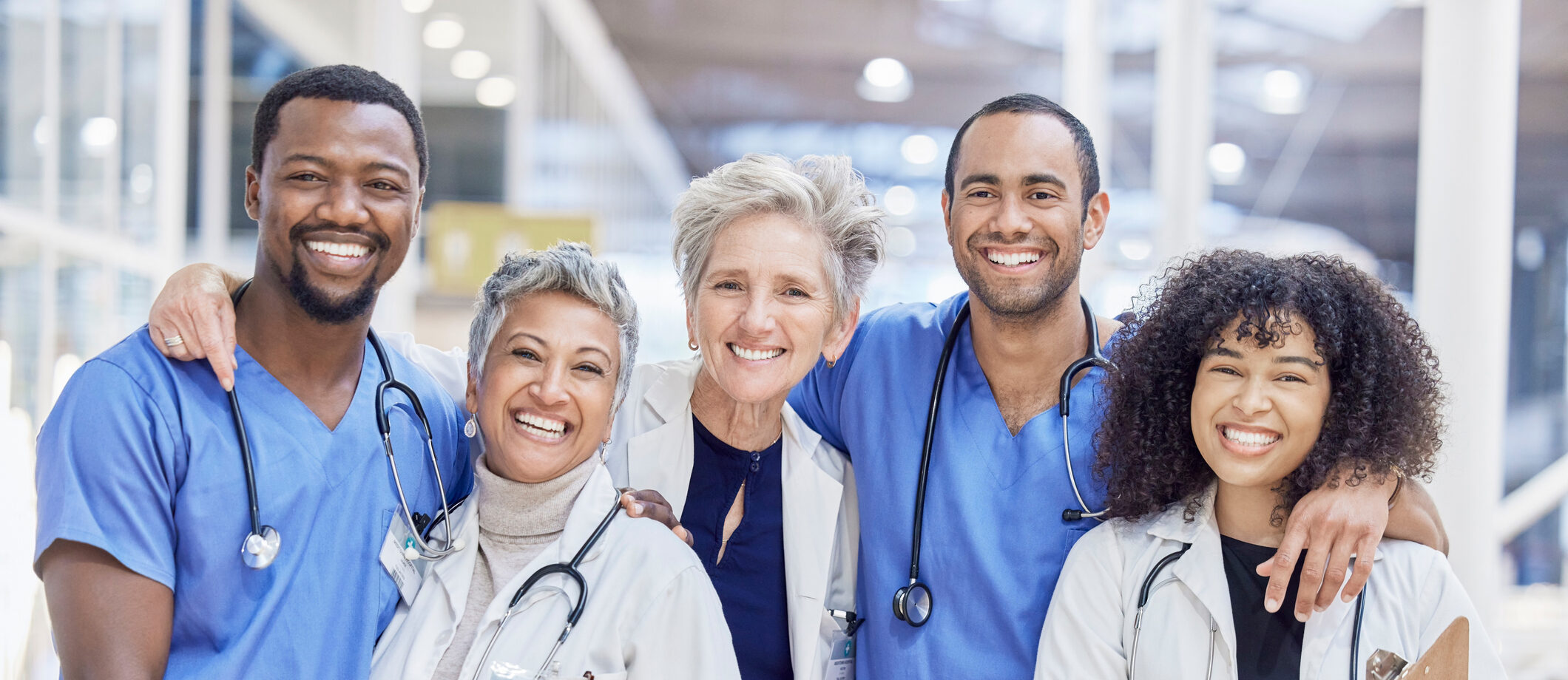 Happy portrait, group and doctors for healthcare service, leadership and teamwork in hospital diversity. Professional medical woman, mentor and internship nurses in clinic management, hug and support customer stories