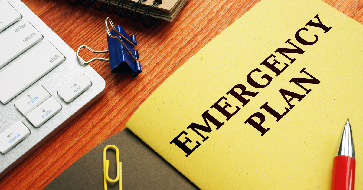 An emergency plan booklet on a wooden desk, symbolizing preparedness and disaster recovery planning in healthcare settings. The image emphasizes the importance of having a comprehensive disaster recovery plan that addresses the evacuation and return of residents/patients, ensuring continuity of care, and managing critical services during emergencies.