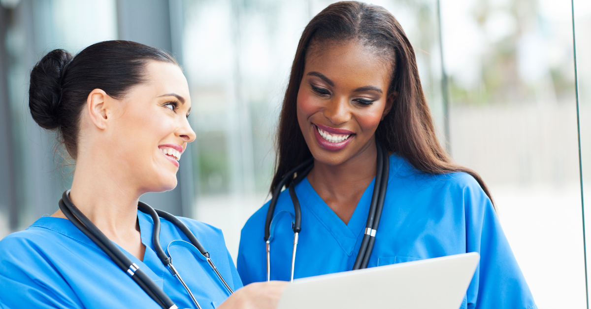 Two nurses using a tablet, showcasing effective tech implementation strategies in healthcare.