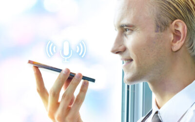 Smiling doctor using phone for ambient scribes.
