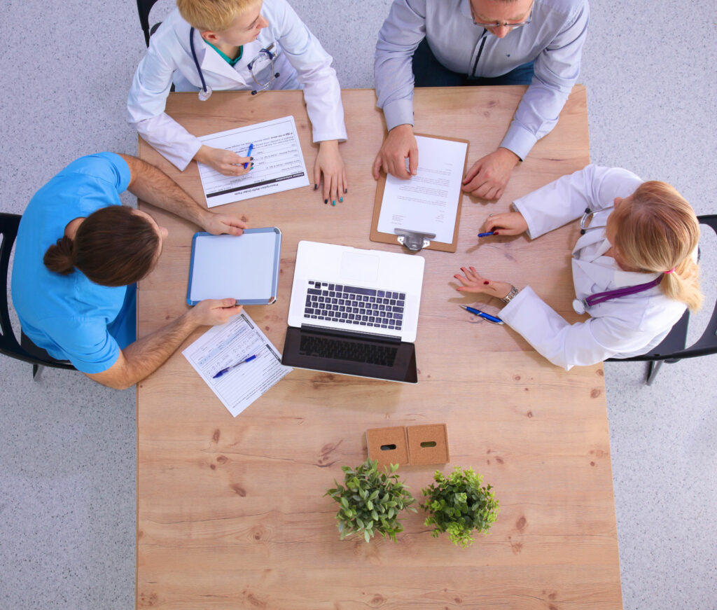 Colleagues sitting around a wooden table